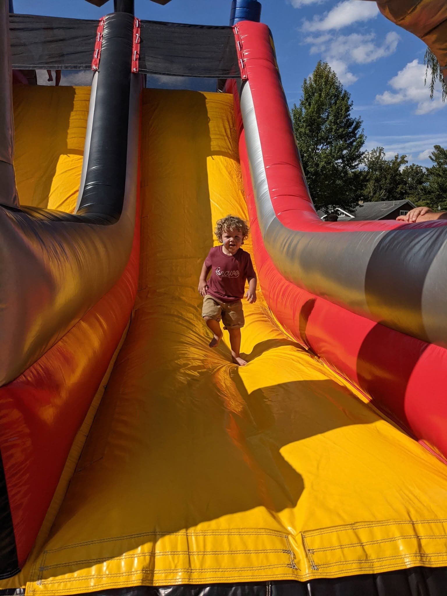 A child using a bounce-house slide at Jackson’s Mill Jubilee