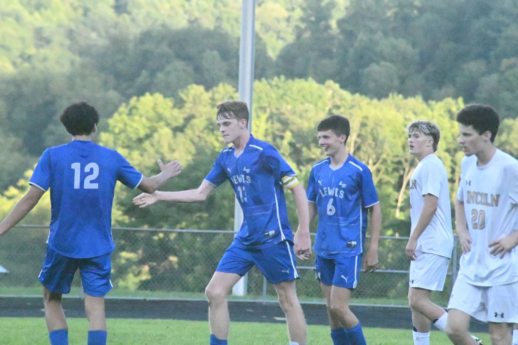 Lewis County and Lincoln players in the season-opening soccer doubleheader