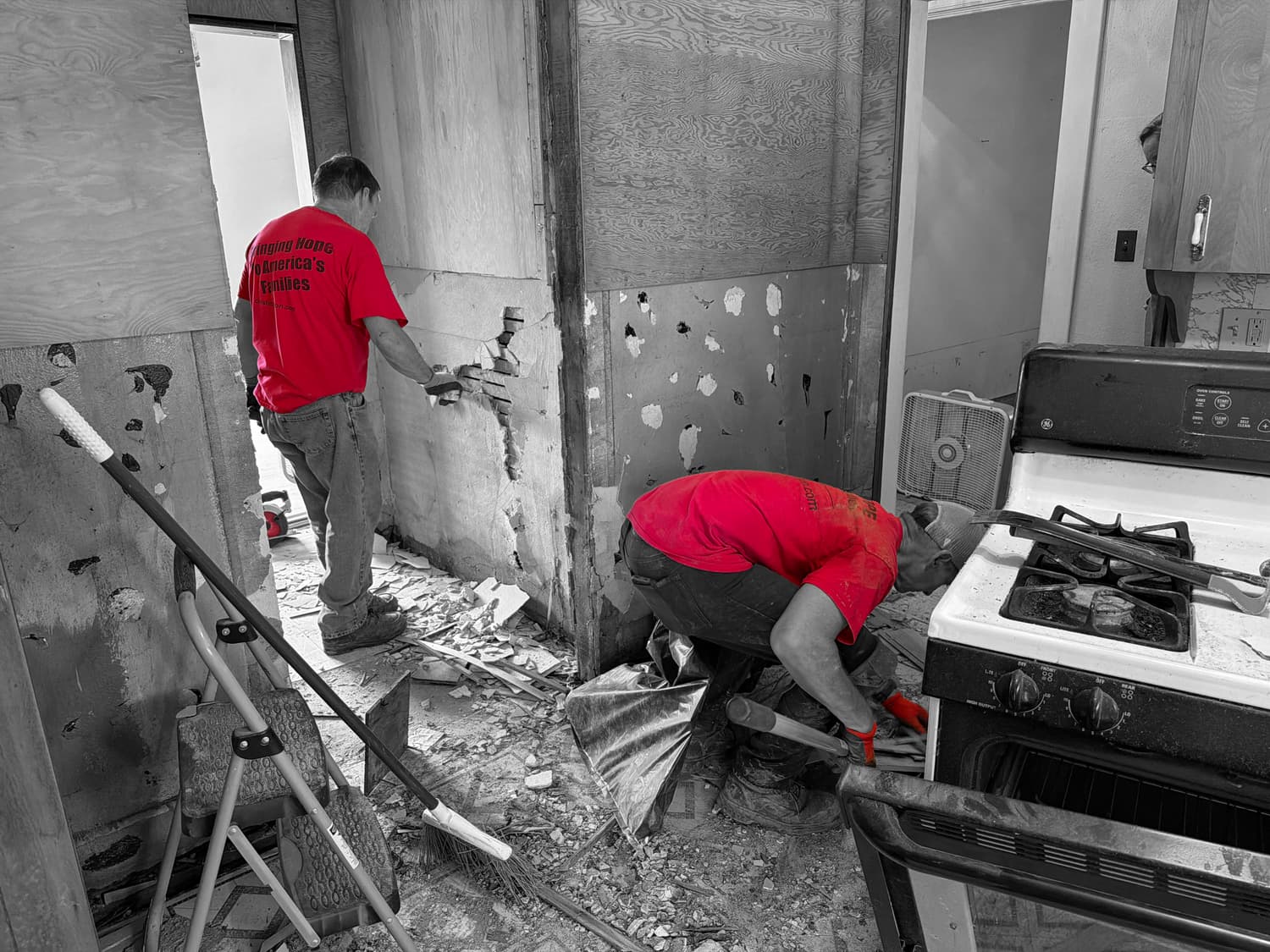 Christ In Action volunteers remove flood-damaged material from a home