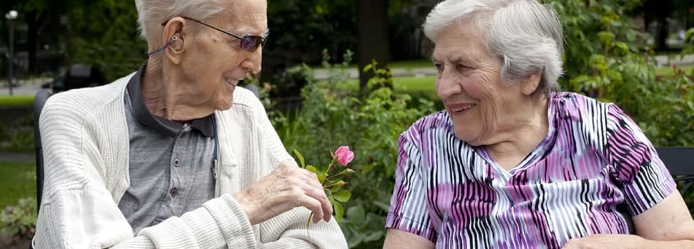 Two seniors visiting outdoors